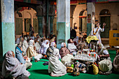 Widows praying in a Bhajan ashram, Vrindavan, Mathura district, India
