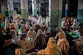 Widows praying in a Bhajan ashram, Vrindavan, Mathura district, India