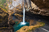 A person at Berglistuber waterfall during spring, Linthal Klausenpass, Cantone Glarona, Switzerland, Western Europe