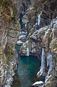 The Orrido di Cossogno gorge in winter with it's iced waterfalls and the San Bernardino torrent viewed from the roman bridge between Cossogno and Rovegro. Val Grande, Verbano Cusio Ossola district, Piedmont, Italy.