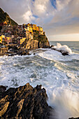 The small village of Manarola at sunset after a storm. Cinque Terre, La Spezia district, Liguria, Italy.