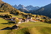 Aerial view of Santa Maddalena's church with the Odle group in the background. Santa Magdalena Val di Funes, Funes Valley, Bolzano, South Tyrol, Trentino Alto Adige, Italy.