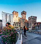 Scaliger Castle of Sirmione, entrance at sunrise with tourist, Lake of Garda, Sirmione, Brescia province, Italy, North Italy, Europe, south Europe