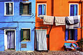 Burano, typical colored houses, orange house; blue house Burano, Venice, Veneto, Italy, south Europe.