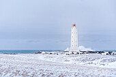 Europe, Iceland: Malarrif Lighthouse and the stormy waves hitting the Snaefellsnes peninsula shore