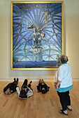 Visitors lying on the ground to admire the perspective of the painting santiago el grande, 1957, salvador dali, monumental representation of the apostle saint james, patron saint of spain, beaverbrook art gallery, fredericton, new brunswick, canada, north america