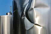 Dented stainless steel wine vats, vini services company, port of blaye, gironde, france