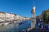 Statue of aurelien evangelisti in front of the canal royal, king of nautical jousts, sete, herault, occitanie, france
