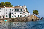 Small beach and bathers in front of the white houses, tourist village where salvador dali lived, cadaques, costa brava, catalonia, spain