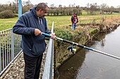 Residents out fishing, care home for adults with moderate mental disabilities, residence du moulin de la risle, rugles, eure, normandy, france