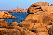View from the pink granite boulders of the ploumanach lighthouse at sunset, renote island point, tregastel, pink granite coast, cotes-d’armor, brittany, france