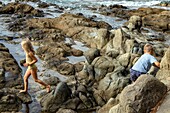 Children playing on the rocks near the port of poussai, cap esterel, saint-raphael, var, france