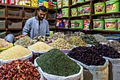 Vendor in front of his herb and dried fruit stand, el dahar market, popular quarter in the old city, hurghada, egypt, africa