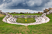 Woman walks in the theatre of one of the most important Samnium archaeological site in Pietrabbondante, Isernia province, Molise, Italy