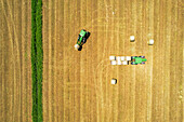 Aerial view of tractor lifting bails of hay, Frosinone province, Ciociaria region, Latium, Central Italy, Italy