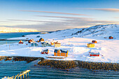 Sunrise over the fishing village of Veines covered with snow, aerial view, Kongsfjord, Varanger Peninsula, Finnmark, Norway