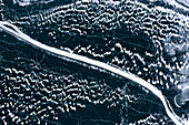 Shapes and details of ice on the frozen surface of Lake Silvaplana, aerial view, Engadine, Graubunden canton, Switzerland