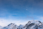 Snowy mountain ridge Biancograt on Piz Bernina and Morteratsch peak at dawn, canton of Graubunden, Engadine, Switzerland