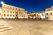 Illuminated Baroque buildings in the ancient Piazza del Duomo square, Lecce, Salento, Apulia, Italy