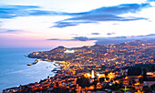 High angle view of Funchal city and bay at dusk from Sao Goncalo, Madeira island, Portugal