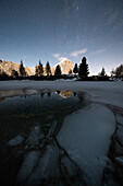 Starry sky over Tofana di Rozes and frozen lake Limides, Dolomites, Cortina d'Ampezzo, Belluno province, Veneto, Italy