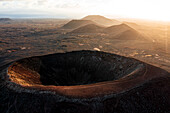 Aerial view of sunrise over the crater of Hondo volcano (Calderon Hondo), Corralejo, Fuerteventura, Canary Islands, Spain