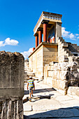 Rear view of little boy with sun hat walking nearby the old Minoan palace of Knossos, Heraklion, Crete, Greece