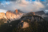 Clouds in the sky at sunset over Cima Ambrizzola and Campanile mountains in spring, aerial view, Dolomites, Veneto, Italy