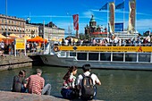 Die Hafenpromenade von Helsinki, mit Touristenmassen und einem Ausflugsboot Helsinki Finnland