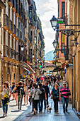 Fermin Calbeton street adorned with the city flag, with San Vicente church in background, located in Parte Vieja, San Sebastian Old Town. Spain