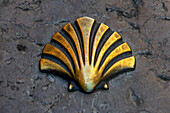 Metal shell indicating the road to Santiago de Compostela in the medieval village of Santillana del Mar in Cantabria, Spain