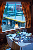 Interior of restaurant car railway carriage of Transcantabrico Gran Lujo luxury train travellong across northern Spain, Europe. First Class dining area railway coach.