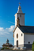 Lucarca lighthouse and white church ( Santuario de la Virgen de la Atalaya or Ermita de Nuestra Señora la Blanca) on the headland of Luarca, Asturian coast Spain