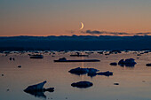 Moonrise at dusk in the Weddell Sea, Antarctica.