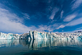 Lilliehook Glacier and its mirror reflection on arctic waters. Lilliehookfjorden, Spitsbergen Island, Svalbard, Norway.
