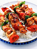 Chicken and pepper skewers on rice