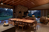 View of dining area in an open living room at dusk