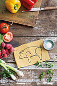 Stillleben mit Gemüse und Zeichnung von einem Schwein