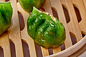 Green vegetable dim sum with gold leaf