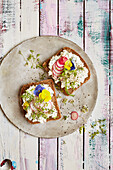 Whole wheat bread with cottage cheese, radishes and edible flowers