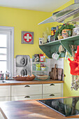 Colourful country kitchen with retro accessories and yellow walls