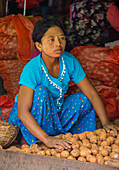 Burmese woman selling vegetables in a market in Shan state Myanmar