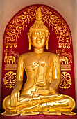 Golden Buddha statue at Wat Fon Soi Buddhist temple in Chiang Mai, Thailand.