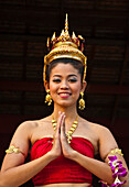 Young Thai woman in traditional costume at Siam Niramit; Bangkok, Thailand.