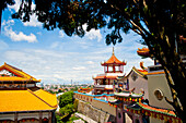 View over George Town from Kek Lok Si Temple, Penang, Malaysia. Kek Lok Si Temple is located in the Air Itam area of Penang, an easy bus ride away from the UNESCO World Heritage Site of George Town, where most tourists stay. Being the Largest Buddhist Temple in Southeast Asia, Kek Lok Si Temple is quite a spectacle with stand out features such as the Pagoda of 10,000 Buddhas and thousands upon thousands of prayers attached to chinese lanterns lining the walk to the top, where you are greeted by views back over George Town, Penang. George Town, named after King George II is a city on Penang Isl