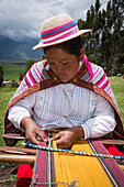 Quechua woman weaving cloth in village of Misminay, Sacred Valley, Peru.
