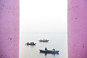 Boats in the mist at dawn on the Ganges River, Varanasi, Uttar Pradesh, India