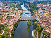 The Tarn River crossing Albi town. Pont Vieux bridge and the Church of Notre Dame du Breuil in Tarn village, Occitanie Midi Pyrenees France.