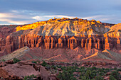 Sunset light on the Mummy Cliff from Panorama Point in Capitol Reef National Park in Utah. The formations look like rows of Egyptian mummies.