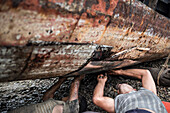 Repairing old fishing boats near Iboih, Pulau Weh Island, Aceh Province, Sumatra, Indonesia